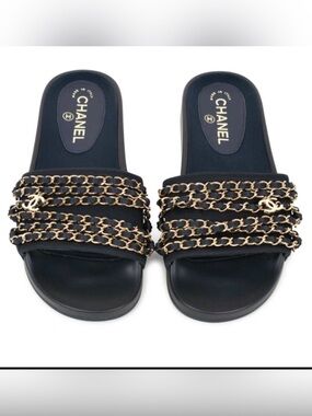 CHANEL navy slides gold chain and CC charms.